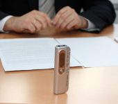 man recording interview dictaphone